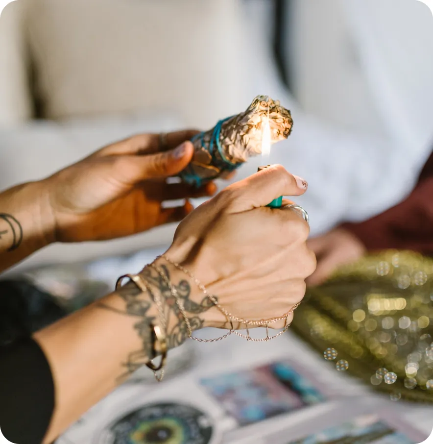 A womanly hand lightning a mystic candle.