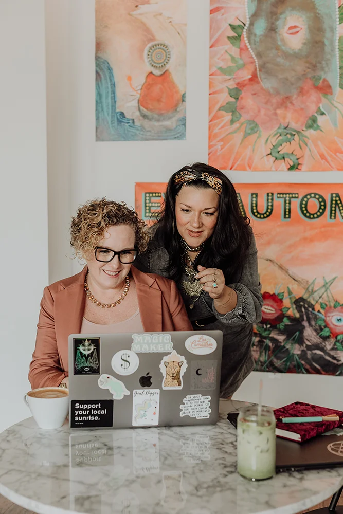 Two women using notebook in a cheerful room